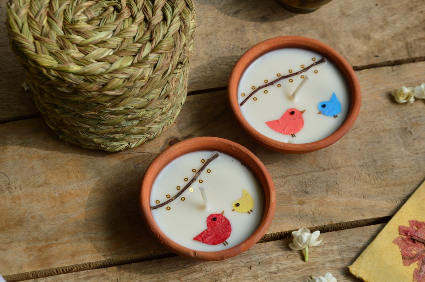Birds under fairy lights terracotta candles in a basket | Sustainable Gifts | Natural Grass Basket