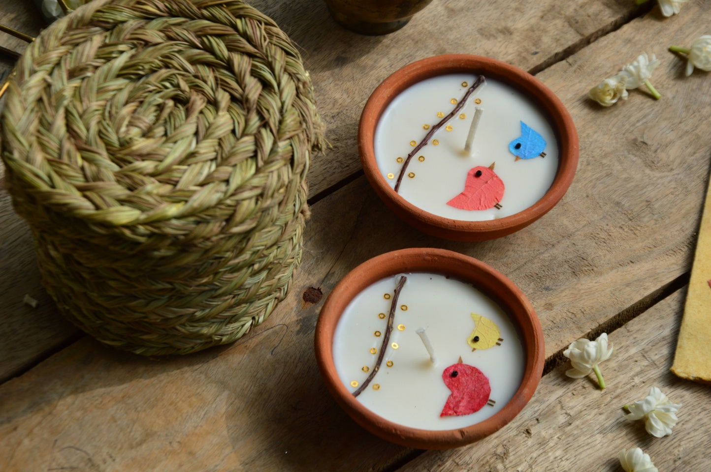 Birds under fairy lights terracotta candles in a basket | Sustainable Gifts | Natural Grass Basket