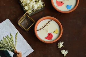 Birds under fairy lights terracotta candles in a basket | Sustainable Gifts | Natural Grass Basket