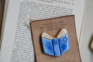 Reading By The Fireside | Hygge Home Ceramic Magnet | Blue Book